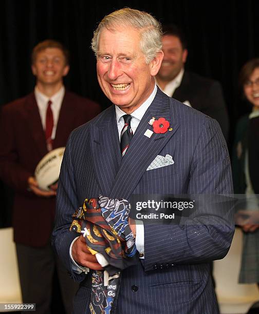 Prince Charles, Prince of Wales smiles after being presented a rugby league shirt while attending a program for indigenous young people "Dream,...