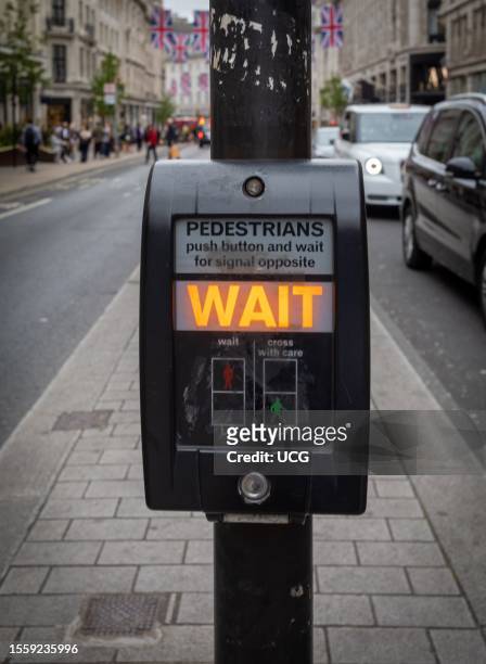 Pushbutton control for pedestrian crossing known as pelican crossing in London, UK.