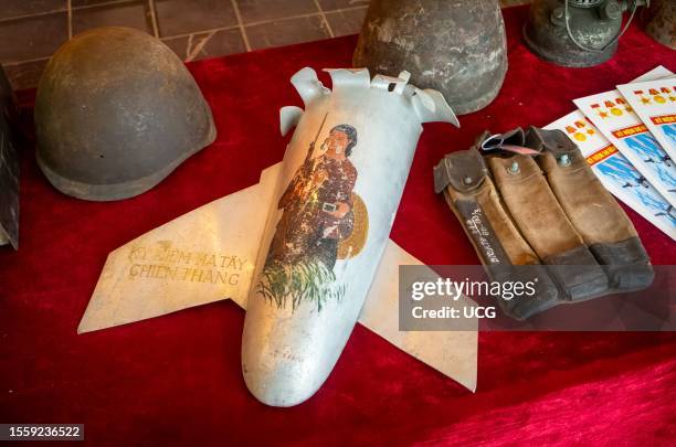 The tail section of a US Vietnam War-era rocket with a painting depicting a female guerilla fighter and the words "Ha Tay War Souvenir" on display in...