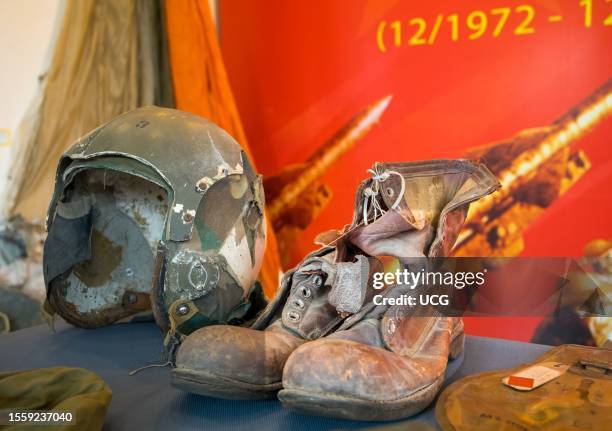 Battered flying helmet and leather boots from a US Airman who was shot down during the "Christmas Bombing" of Hanoi in the Vietnam War in 1972, on...