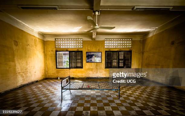Steel bedframe in a torture cell converted from a former school classroom in the Tuol Sleng or S-21 torture and genocide museum in Phnom Penh,...