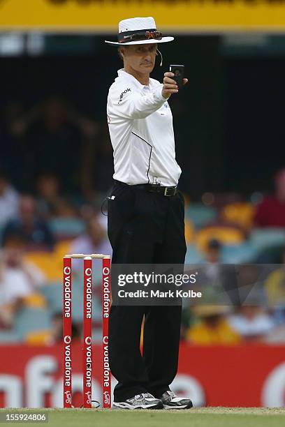 Umpire Billy Bowden read the light before calling a stop to play during day one of the First Test match between Australia and South Africa at The...