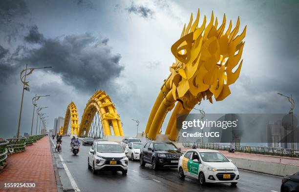 Traffic crosses The Dragon Bridge in the rain in Danang, Vietnam. The bridge puts on a display each weekend with the dragon breathing fire.