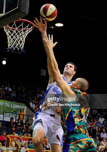 Russell Hinder of the Crocodiles attempts a layup past Alex Pledger of the Breakers during the round six NBL match between the Townsville Crocodiles...