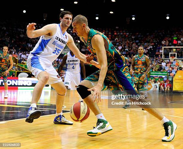 Russell Hinder of the Crocodiles drives past Alex Pledger of the Breakers during the round six NBL match between the Townsville Crocodiles and the...