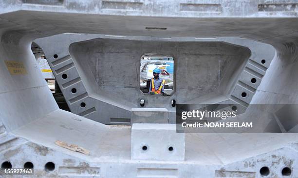 Indian labourers work at the casting yard of L and T construction making segments for the Hyderabad Metro Rail in Hyderabad on November 9, 2012. The...