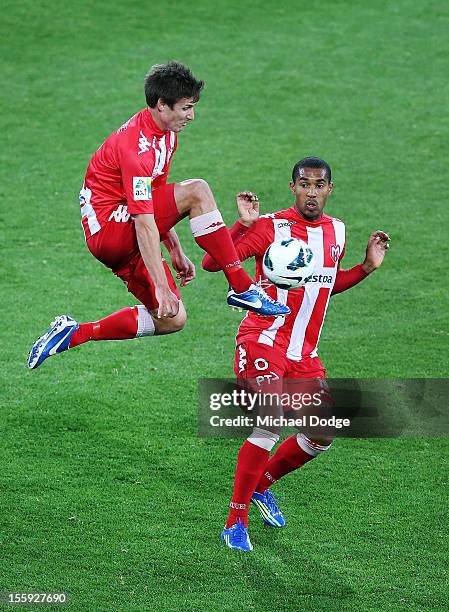 Michael Marrone of the Heart kicks past teammate Patrick Gerhardt during the round six A-League match between the Melbourne Heart and the Brisbane...