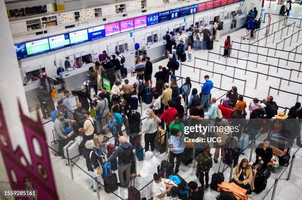 People queue to check in at Gatwick Airport, South Terminal.