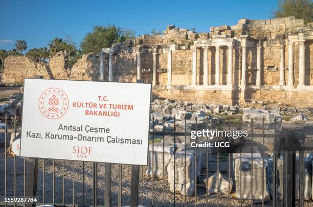 Sign describing conservation work going on at the Monumental Fountain within the ancient Roman city at Side in Turkey. Sign reads, Cultural and...