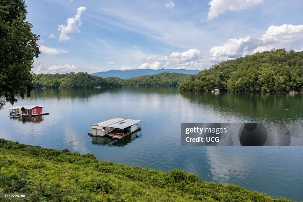 View of a house boats on Fontana Lake as seen from the open air car of the Great Smoky Mountains Railroad on its excursion from Bryson City, North Carolina