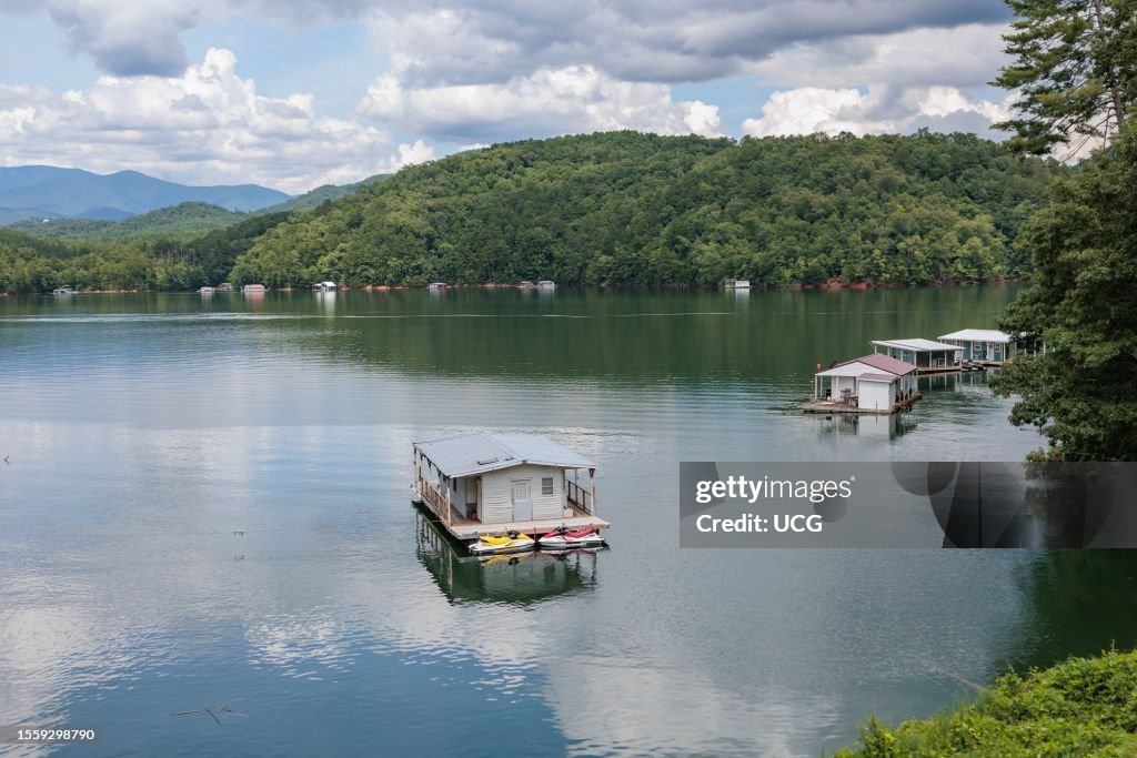 View of a house boats on Fontana Lake as seen from the open air car of the Great Smoky Mountains Railroad on its excursion from Bryson City, North Carolina
