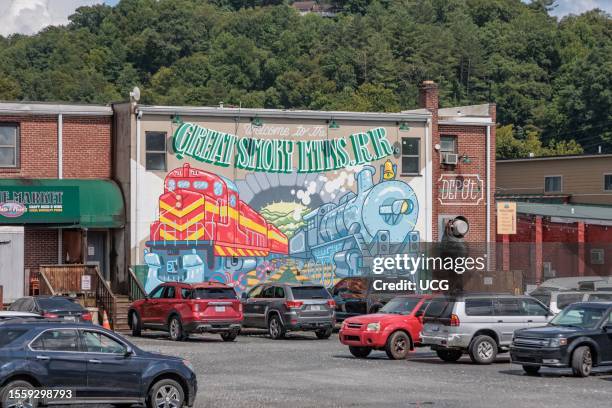 Mural on the back of a building welcomes Great Smoky Mountains Railroad passengers back to Bryson City, North Carolina.