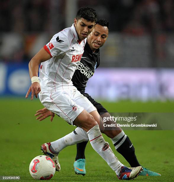 Adil Chihi of Cologne and Antonio da Silva of Duisburg battle for the ball during the Second Bundesliga match between 1. FC Koeln and MSV Duisburg at...