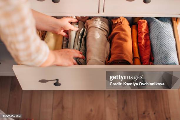 chest of drawers with hand clothes - kast stockfoto's en -beelden