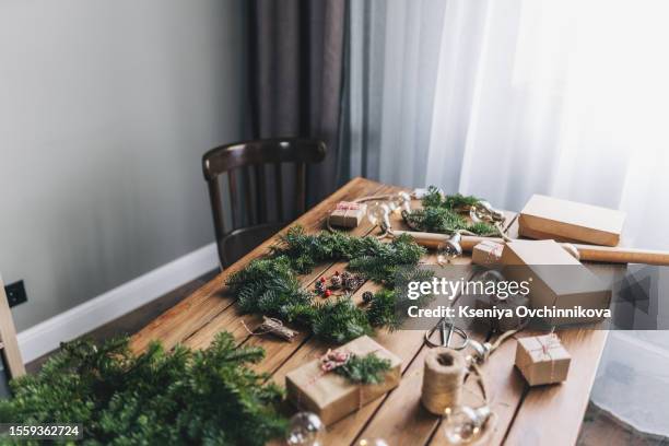 woman making christmas wreath at table, closeup - christmas gala stock pictures, royalty-free photos & images