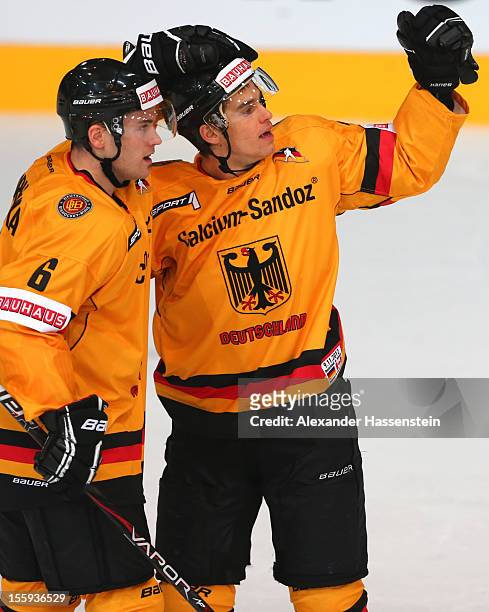 Marcus Kink of Germany celebrates scoring the fisrt goal with his team mate Florian Ondruschka during the German Ice Hockey Cup 2012 first round...