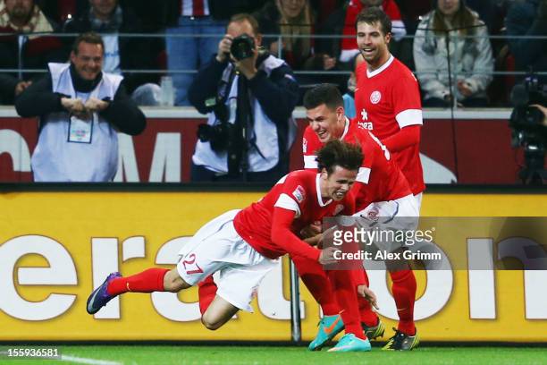 Nicolai Mueller celebrates his team's first goal with team mates Adam Szalai and Andreas Ivanschitz during the Bundesliga match between 1. FSV Mainz...