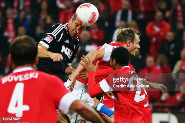 Per Nilsson of Nuernberg scores his team's first goal against Bo Svensson of Mainz during the Bundesliga match between 1. FSV Mainz 05 and 1. FC...