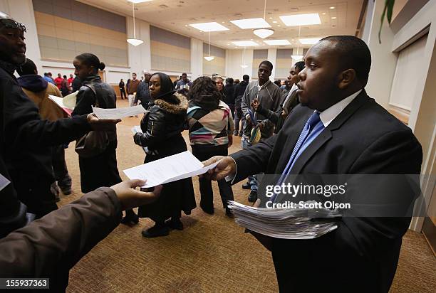 Cory Thames, with the city of Chicago human resources department, collects resumes from Job seekers as they enter a job fair being held at...