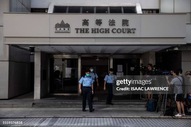 Police personnel patrol at the High Court in Hong Kong on July 28, 2023. A Hong Kong judge denied on July 28, 2023 a government request for an...