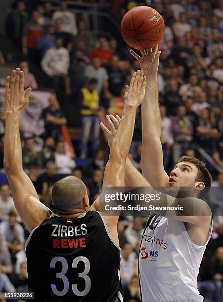 Dejan Musli of BC Partizan shoots over Maik Zirbes of Brose Baskets Bamberg during the 2012-2013 Turkish Airlines Euroleague Regular Season Game Day...