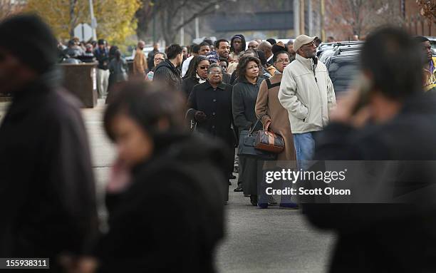 Job seekers wait in line at Kennedy-King College to attend a job fair hosted by the city of Chicago on November 9, 2012 in Chicago, Illinois....