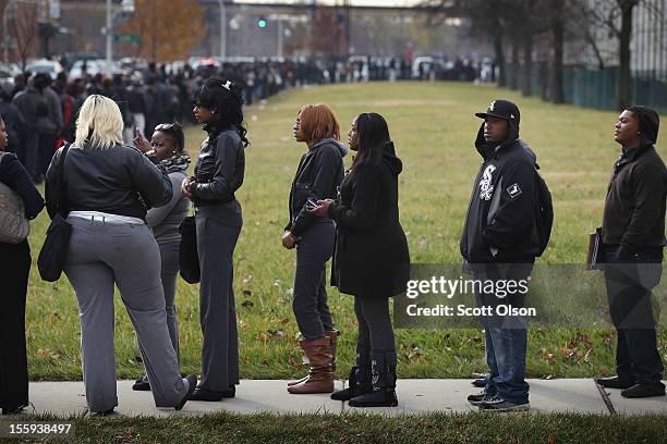 Job seekers wait in line at Kennedy-King College to attend a job fair hosted by the city of Chicago on November 9, 2012 in Chicago, Illinois....