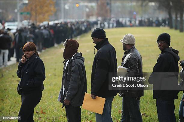 Job seekers wait in line at Kennedy-King College to attend a job fair hosted by the city of Chicago on November 9, 2012 in Chicago, Illinois....