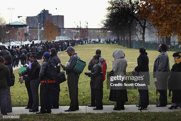 Job seekers wait in line at Kennedy-King College to attend a job fair hosted by the city of Chicago on November 9, 2012 in Chicago, Illinois....