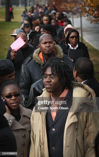 Job seekers wait in line at Kennedy-King College to attend a job fair hosted by the city of Chicago on November 9, 2012 in Chicago, Illinois....