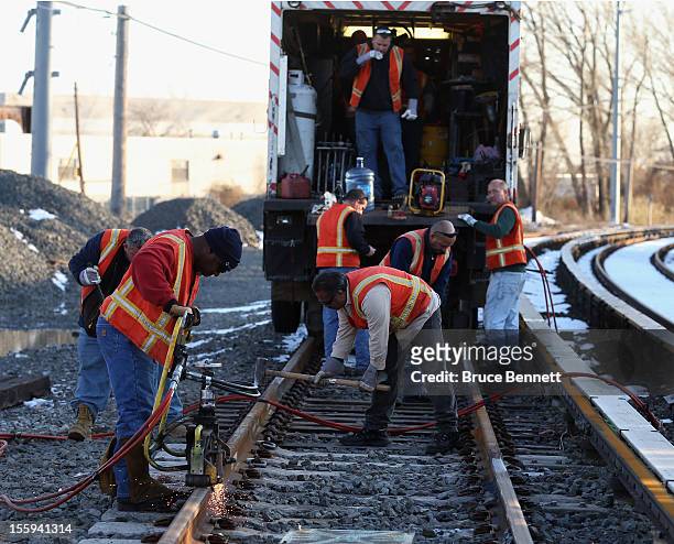 Long Island Railroad workers work to repair tracks just east of Long Beach Road in the aftermath of Superstorm Sandy on November 9, 2012 in Island...