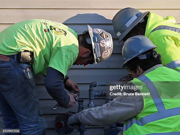 National Grid workers continue their clean up effort on gas lines in the aftermath of Superstorm Sandy on November 9, 2012 in Island Park, New York....