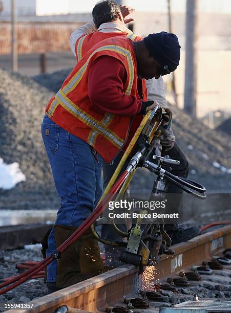 Long Island Railroad workers work to repair tracks just east of Long Beach Road in the aftermath of Superstorm Sandy on November 9, 2012 in Island...