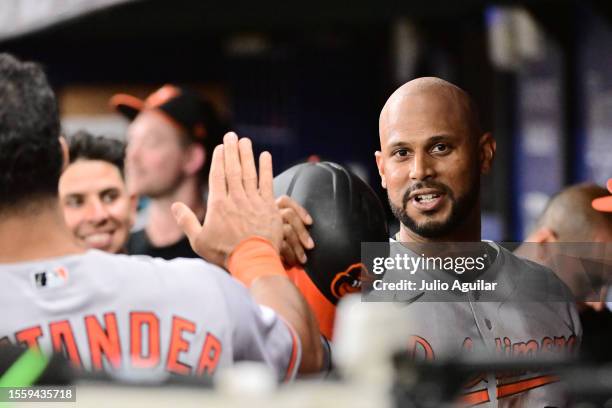 Aaron Hicks of the Baltimore Orioles celebrates with Anthony Santander after scoring the go-ahead run in the tenth inning against the Tampa Bay Rays...