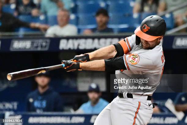 Colton Cowser of the Baltimore Orioles hits a sacrifice fly to score Aaron Hicks in the tenth inning against the Tampa Bay Rays at Tropicana Field on...