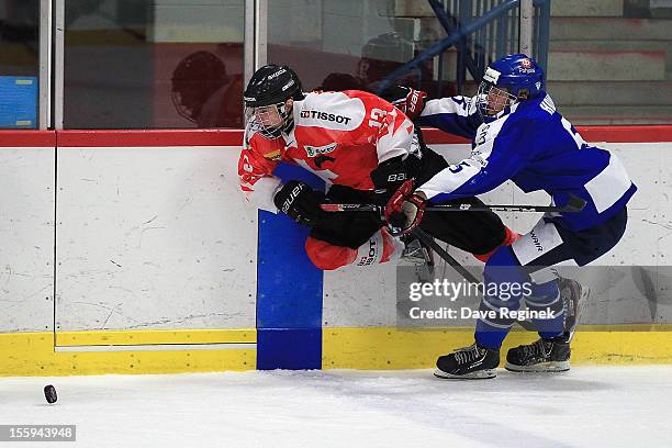 Luca Hischier of Switzerland is tripped up by Julius Honka of Finland during the U-18 Four Nations Cup tournament on November 9, 2012 at the Ann...