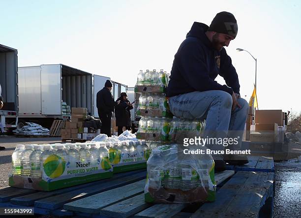 Matt Gassert takes a break at a food distribution site run by the Town of Hempstead in cooperation with FEMA at Oceanside Park during in the...