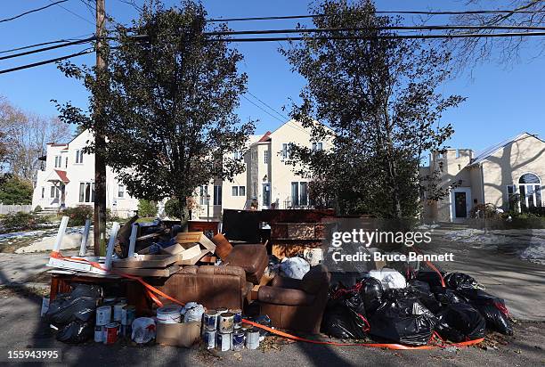 Frankel Boulevard is littered with contents from flooded homes in the aftermath of Superstorm Sandy on November 9, 2012 in Merrick, New York. New...