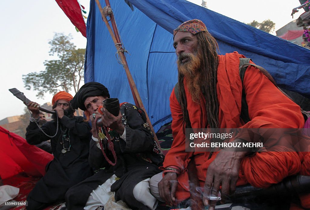 Pakistan Rufi Pakistani Muslim devotees blow the horns as a muslim Sufi smokes next ...
