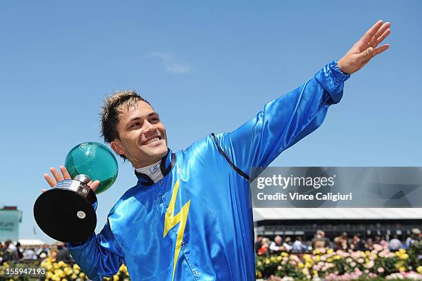 Jockey Michael Walker poses with trophy after winning Momentum Energy Trophy during 2012 Emirates Stakes Day at Flemington Racecourse on November 10,...