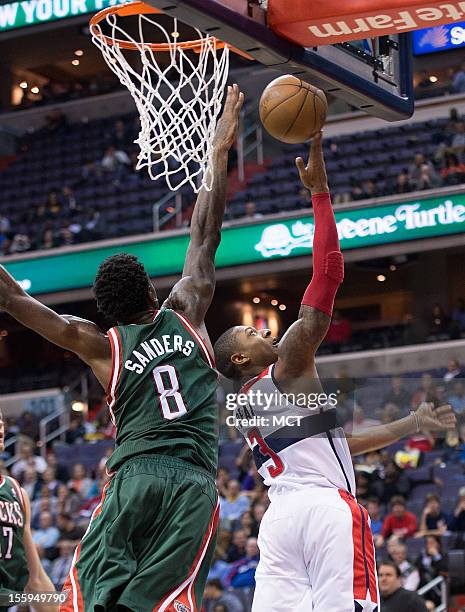 Washington Wizards shooting guard Bradley Beal shoots a reverse layup over Milwaukee Bucks center Larry Sanders during the second half of their game...