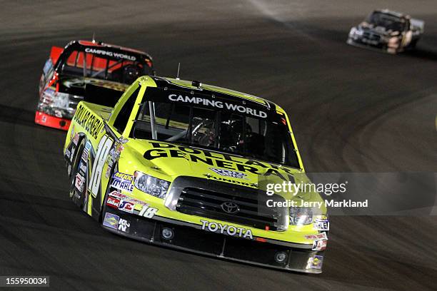 Brian Scott, driver of the Dollar General Toyota, and Ty Dillon, driver of the Bass Pro Shops/Tracker Boats Chevrolet, drive during the NASCAR...