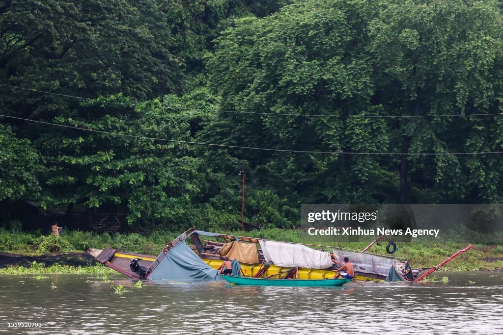 Capsized Rowing Boat The capsized boat is seen as rescuers from the Philippine Coast Guard ...