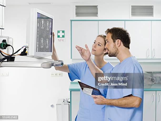 Surgeon Using Monitor Surgeons Looking At Monitor Using Digital Tablet High-Res Stock Photo ...