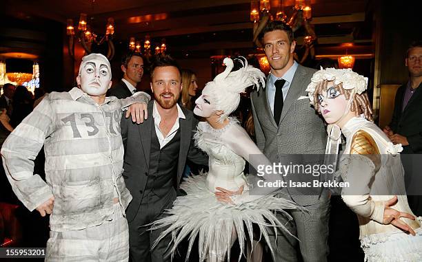 Actor Aaron Paul and Arizona Cardinals linebacker Stewart Bradley appear with "Zarkana by Cirque du Soleil" characters at the reception for the Las...
