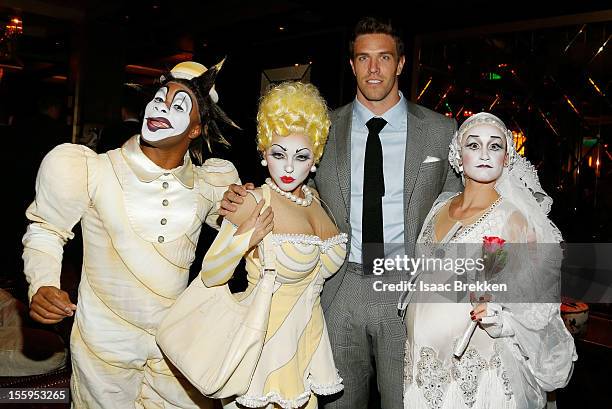 Arizona Cardinals linebacker Stewart Bradley appear with "Zarkana by Cirque du Soleil" characters at the reception for the Las Vegas premiere of...