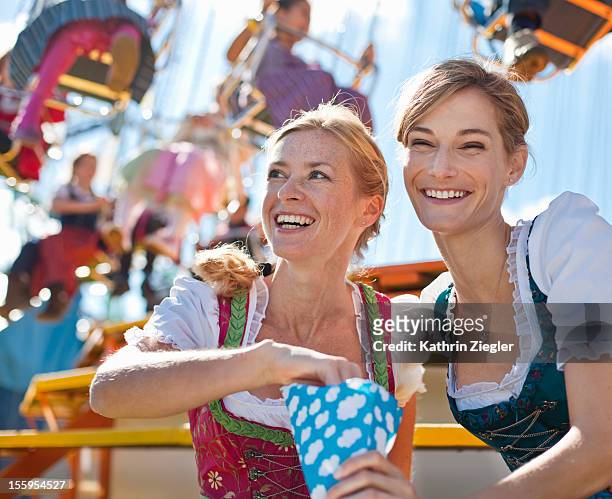 two women enjoying beer fest - oktoberfest fotografías e imágenes de stock