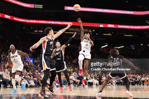 Dana Evans of the Chicago Sky attempts a shot over Sug Sutton and Brittney Griner of the Phoenix Mercury during the first half of the WNBA game at...