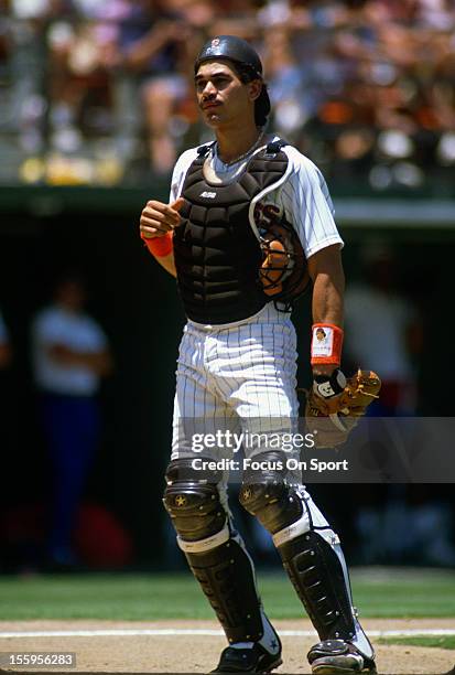 Benito Santiago of the San Diego Padres looks on during an Major League Baseball game circa 1989 at Jack Murphy Stadium in San Diego, California....