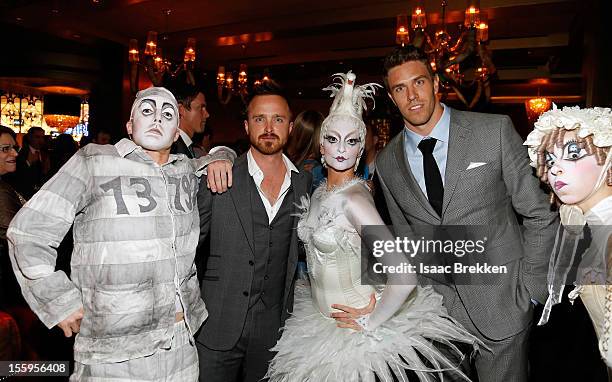 Actor Aaron Paul and Arizona Cardinals linebacker Stewart Bradley appear with "Zarkana by Cirque du Soleil" characters at the reception for the Las...